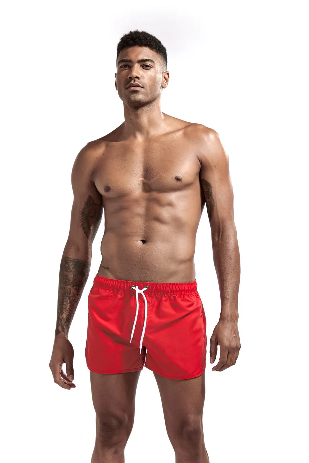 Man wearing red swim shorts on a white background